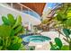 Exterior hot tub with lush tropical landscaping and resort style amenities at 1035 Seaside Dr # 603, Sarasota, FL 34242