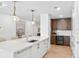 Elegant kitchen featuring stainless steel appliances, custom cabinets, and stylish island seating at 1035 Seaside Dr # 603, Sarasota, FL 34242