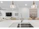 Bright kitchen featuring white countertops, a stainless steel sink, and modern pendant lighting at 1035 Seaside Dr # 603, Sarasota, FL 34242