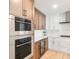 Modern kitchen with stainless steel appliances, and a wine cooler at 1035 Seaside Dr # 603, Sarasota, FL 34242