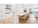 Modern kitchen with white cabinetry, large island with seating, and ocean views at 1035 Seaside Dr # 603, Sarasota, FL 34242