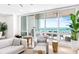 Living room with ocean view, comfortable seating, and access to balcony at 1035 Seaside Dr # 603, Sarasota, FL 34242