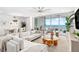 Bright living room with ocean views, modern furnishings, and open floor plan at 1035 Seaside Dr # 603, Sarasota, FL 34242