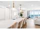 Bright open-concept living space with modern lighting and ocean views at 1035 Seaside Dr # 603, Sarasota, FL 34242
