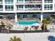 Aerial view of outdoor pool with lounge chairs and umbrellas, with beach access at 1035 Seaside Dr # 603, Sarasota, FL 34242
