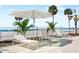 Lounge seating under an umbrella on the pool deck of this beachfront property at 1035 Seaside Dr # 603, Sarasota, FL 34242