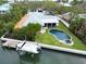 Beautiful waterfront home featuring a boat lift, backyard pool and patio on a meticulously landscaped lot at 110 Faubel St, Sarasota, FL 34242