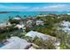 Serene aerial perspective of the waterfront home, private pool, and stunning coastal backdrop at 110 Faubel St, Sarasota, FL 34242