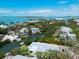 Aerial view showcasing the coastal neighborhood, canal-front homes, and stunning waterfront views at 110 Faubel St, Sarasota, FL 34242