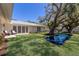 Picturesque backyard with a reflecting pool, large tree, and well-manicured lawn at 110 Faubel St, Sarasota, FL 34242