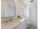 This bathroom features a modern vanity with marble countertop and a large, arched mirror at 110 Faubel St, Sarasota, FL 34242