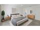 A modern bedroom with neutral tones, a ceiling fan, and views to the hall and ensuite bathroom at 110 Faubel St, Sarasota, FL 34242