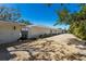 The home's exterior with a gravel driveway and beautiful landscaping around the perimeter of the property at 110 Faubel St, Sarasota, FL 34242