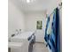 A laundry room with a washer and dryer, adjacent to an exterior door with natural light from the backyard at 110 Faubel St, Sarasota, FL 34242