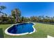Lovely pool and spa combo with lush landscaping alongside a waterway at 110 Faubel St, Sarasota, FL 34242