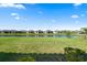 Serene view of multiple homes overlooking a peaceful lake at 11127 Devonbridge Dr, Palmetto, FL 34221