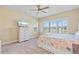 Comfortable bedroom with a ceiling fan, a window with shutters, and a six-drawer dresser with a TV on top at 11127 Devonbridge Dr, Palmetto, FL 34221