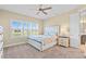 Cozy bedroom with a large window, ceiling fan, and a comfortable bed with decorative pillows at 11127 Devonbridge Dr, Palmetto, FL 34221