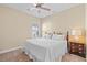 Bedroom featuring a ceiling fan, shuttered windows, and a nightstand with a lamp at 11127 Devonbridge Dr, Palmetto, FL 34221