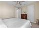 Bedroom with ceiling fan, four-drawer chest, and doorways to the bathroom and hallway at 11127 Devonbridge Dr, Palmetto, FL 34221