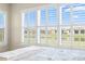 A bedroom window with white shutters overlooking a green lawn, a pond, and a row of houses at 11127 Devonbridge Dr, Palmetto, FL 34221