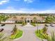 Beautiful clubhouse with tile roof, lush landscaping, palm trees and convenient parking at 11127 Devonbridge Dr, Palmetto, FL 34221