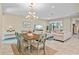 Spacious dining room with chandelier, tile floors and backyard view at 11127 Devonbridge Dr, Palmetto, FL 34221