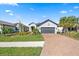 Attractive single-story home featuring a paver driveway and meticulous landscaping at 11127 Devonbridge Dr, Palmetto, FL 34221