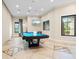 Spacious game room featuring a pool table, modern lighting, and stylish decor at 11127 Devonbridge Dr, Palmetto, FL 34221
