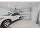 Spacious two car garage with white door and concrete floor, featuring a parked white SUV at 11127 Devonbridge Dr, Palmetto, FL 34221