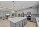 Open kitchen showcasing an island and seamless flow into the living area at 11127 Devonbridge Dr, Palmetto, FL 34221