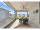 Enjoy this lovely screened patio with ceiling fan and view of pond and backyard at 11127 Devonbridge Dr, Palmetto, FL 34221