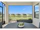 Screened-in patio overlooking the landscaped yard and tranquil pond at 11127 Devonbridge Dr, Palmetto, FL 34221