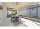 Relaxing screened patio features a ceiling fan and outdoor dining area at 11127 Devonbridge Dr, Palmetto, FL 34221