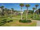 Picturesque community grounds featuring lush lawns and palm trees at 1145 Gulf Of Mexico Dr # 301, Longboat Key, FL 34228