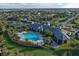 Aerial view of a community center with a pool, tennis courts, and outdoor lounge at 12370 Marsh Pointe Rd, Sarasota, FL 34238