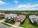 Beautiful home showcases lush landscaping, a brick driveway and a well-maintained tile roof at 12370 Marsh Pointe Rd, Sarasota, FL 34238