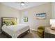 Bright bedroom featuring a full size bed, chair, and neutral decor at 12370 Marsh Pointe Rd, Sarasota, FL 34238