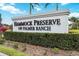 Entrance sign to Hammock Preserve on Palmer Ranch, with lush landscaping and palm trees at 12370 Marsh Pointe Rd, Sarasota, FL 34238
