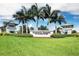 Community sign for Hammock Preserve on Palmer Ranch, framed by towering palm trees and green lawns at 12370 Marsh Pointe Rd, Sarasota, FL 34238