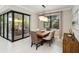 Beautiful dining room with large window, modern chandelier, and access to outdoor living area at 12370 Marsh Pointe Rd, Sarasota, FL 34238
