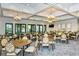 Dining room with seating for many, elegant light fixtures, and multiple windows at 12370 Marsh Pointe Rd, Sarasota, FL 34238