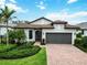 Charming single-story home with a well-manicured lawn, tile roof and a two-car garage at 12370 Marsh Pointe Rd, Sarasota, FL 34238