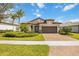 Charming single-story home with a well-manicured lawn, tile roof, and a two-car garage at 12370 Marsh Pointe Rd, Sarasota, FL 34238
