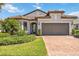 Beautiful single-Gathering home with a well-manicured lawn and a spacious two-car garage at 12370 Marsh Pointe Rd, Sarasota, FL 34238
