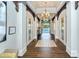 Elegant hallway with wood floors, arched doorways and view of the outdoor pool at 12370 Marsh Pointe Rd, Sarasota, FL 34238