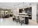 Bright open kitchen with dark cabinets, large island with seating, and stainless steel appliances at 12370 Marsh Pointe Rd, Sarasota, FL 34238