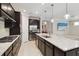 Well-equipped kitchen with dark cabinetry, a large island, and stainless steel appliances at 12370 Marsh Pointe Rd, Sarasota, FL 34238