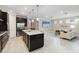 Modern kitchen with an island, stainless steel appliances, and views into the adjacent living area at 12370 Marsh Pointe Rd, Sarasota, FL 34238