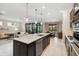 Open-concept kitchen featuring a large island with granite countertops and stainless steel appliances at 12370 Marsh Pointe Rd, Sarasota, FL 34238